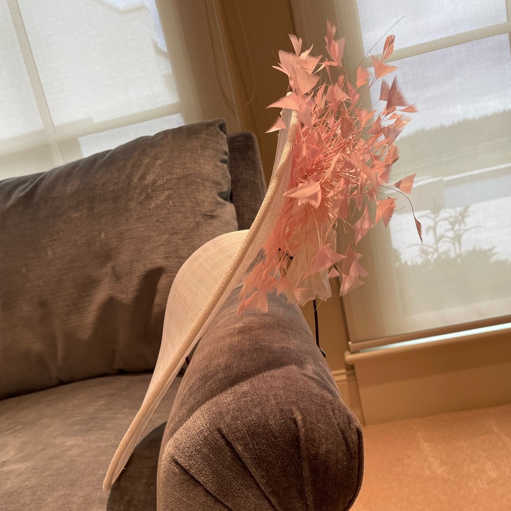 Feminine elegance at its finest! Off-white fascinator with pink & white details.